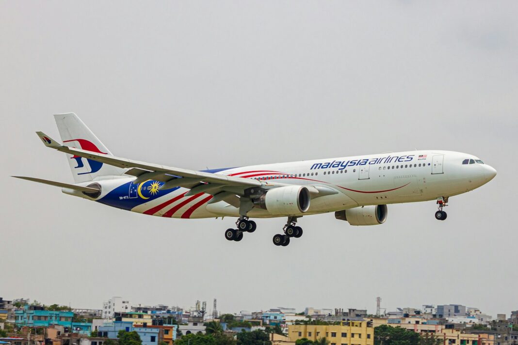 A large jetliner flying through a cloudy sky